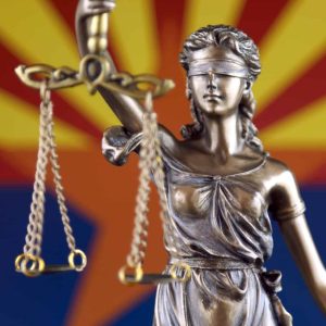 Figure of lady justice in front of AZ flag, AZ Probate FAQ, Cholewka Law, Gilbert AZ